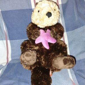 Brown and Cream Stuffed Otter with Pink Starfish